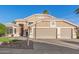 Beautiful single Gathering home featuring a three car garage and manicured landscaping at 1321 N Bronco Ct, Gilbert, AZ 85233