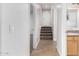 Hallway featuring a stairway, and a view of a bathroom with double vanity sinks at 1321 N Bronco Ct, Gilbert, AZ 85233