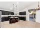 Modern kitchen with stainless steel appliances, dark cabinetry, an island with seating, and access to the pool area at 1321 N Bronco Ct, Gilbert, AZ 85233