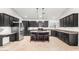 Modern kitchen with dark cabinetry, stainless appliances, and a center island at 1321 N Bronco Ct, Gilbert, AZ 85233