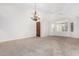 Large living room with neutral colors, carpeted floor, and elegant chandelier at 1321 N Bronco Ct, Gilbert, AZ 85233