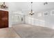 Expansive living area featuring neutral paint, plush carpet, and stylish lighting at 1321 N Bronco Ct, Gilbert, AZ 85233