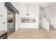 Bright open living room with access to outdoor views, a staircase, and tan-colored tile flooring at 1321 N Bronco Ct, Gilbert, AZ 85233