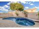 Sparkling pool with a built-in spa, waterfall feature, and desert landscaping at 1321 N Bronco Ct, Gilbert, AZ 85233