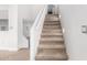 Stairway featuring neutral carpet, white walls and a contemporary lighting design at 1321 N Bronco Ct, Gilbert, AZ 85233