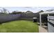 Spacious backyard featuring a well-maintained lawn, block wall fencing, and outdoor grill at 1409 E Apollo Rd, Phoenix, AZ 85042