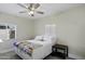 Inviting bedroom with a ceiling fan, bright windows, and a comfortable bed with decorative quilt at 1409 E Apollo Rd, Phoenix, AZ 85042