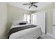 Bedroom with a ceiling fan and a large bed with fresh linens at 1409 E Apollo Rd, Phoenix, AZ 85042