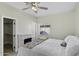 Bright bedroom with a fireplace, closet, a ceiling fan, and a comfortable bed with decorative quilt at 1409 E Apollo Rd, Phoenix, AZ 85042