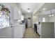 Bright kitchen featuring white cabinetry, stainless steel appliances and tiled backsplash at 1409 E Apollo Rd, Phoenix, AZ 85042