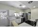 Well-lit kitchen with stainless steel appliances, white cabinets, and a bright window over the sink at 1409 E Apollo Rd, Phoenix, AZ 85042