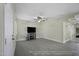 Spacious living room with gray tile floors and an entertainment center with a fireplace at 1409 E Apollo Rd, Phoenix, AZ 85042