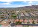 An expansive aerial view showcases a vibrant community with tree-lined streets and distant mountains against a blue sky at 1432 E Pedro Rd, Phoenix, AZ 85042