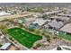 Aerial view of a community with desert landscaping, pools, and green spaces at 1432 E Pedro Rd, Phoenix, AZ 85042