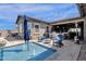 Backyard oasis featuring a pool, outdoor kitchen, seating, patio, and string lights at 1432 E Pedro Rd, Phoenix, AZ 85042