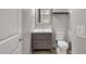 Bathroom boasts a modern vanity with a gray cabinet, stylish mirror, and wood look tile flooring at 1432 E Pedro Rd, Phoenix, AZ 85042