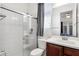 Modern bathroom showcasing a glass-enclosed shower, dark vanity, mirror, and toilet at 1432 E Pedro Rd, Phoenix, AZ 85042