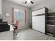 A guest room with a murphy bed, desk, and light wood-look tile floors at 1432 E Pedro Rd, Phoenix, AZ 85042