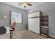This bedroom features a murphy bed, desk, and views of the backyard at 1432 E Pedro Rd, Phoenix, AZ 85042