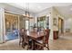 Dining room features tile floors, wooden table with seating for eight, and sliding glass doors to the patio at 1432 E Pedro Rd, Phoenix, AZ 85042