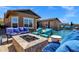 Inviting outdoor space with a stone firepit and a swimming pool, ideal for relaxation and social gatherings at 1432 E Pedro Rd, Phoenix, AZ 85042