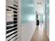 Hallway features light aqua colored walls, white wainscoting, and wood look tile flooring at 1432 E Pedro Rd, Phoenix, AZ 85042