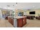 Kitchen with a large island, stainless steel sink, and open layout to the dining and living areas at 1432 E Pedro Rd, Phoenix, AZ 85042