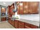 Well-equipped kitchen featuring stainless steel appliances, a tile backsplash, and wood cabinets at 1432 E Pedro Rd, Phoenix, AZ 85042