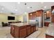 Open-concept kitchen with island seating, stainless steel appliances, and plenty of counter space at 1432 E Pedro Rd, Phoenix, AZ 85042