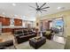 Spacious living room showcases open layout, plush leather furniture, and sliding glass doors to the patio at 1432 E Pedro Rd, Phoenix, AZ 85042