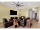 Comfortable living room featuring a large television, leather furniture, and neutral decor at 1432 E Pedro Rd, Phoenix, AZ 85042