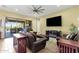 Cozy living room leading to an outdoor patio and pool area, complete with modern decor and tile flooring at 1432 E Pedro Rd, Phoenix, AZ 85042