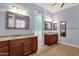 Main bathroom features dual vanity sinks, framed mirrors, and wood look tile floors at 1432 E Pedro Rd, Phoenix, AZ 85042