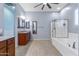 Bright main bathroom with a soaking tub, glass enclosed shower, dual sink vanity and tile floors at 1432 E Pedro Rd, Phoenix, AZ 85042