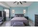 Spacious main bedroom featuring a ceiling fan, soft blue walls, and comfortable furnishings at 1432 E Pedro Rd, Phoenix, AZ 85042