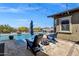 Backyard pool with blue Adirondack chairs and a fire pit, perfect for relaxing at 1432 E Pedro Rd, Phoenix, AZ 85042