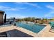 Resort-style backyard pool with a waterfall, landscaping, and a telescope at 1432 E Pedro Rd, Phoenix, AZ 85042