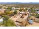 Desert home featuring lush landscaping, backyard fire pits, and additional buildings in a desirable community at 14418 N San Carlos Dr, Fountain Hills, AZ 85268
