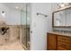 Bathroom with a tiled walk-in shower with glass door and a wooden vanity with a mirror at 14418 N San Carlos Dr, Fountain Hills, AZ 85268