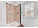 Bathroom with a walk-in shower featuring tiled walls and glass door, plus a door to the exterior at 14418 N San Carlos Dr, Fountain Hills, AZ 85268
