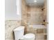 Elegant bathroom features travertine tile, a built-in tub with shower, and modern fixtures at 14418 N San Carlos Dr, Fountain Hills, AZ 85268