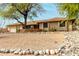 Single-story home featuring desert landscaping, mature tree, and a two-car garage at 14418 N San Carlos Dr, Fountain Hills, AZ 85268