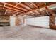 A large open garage with white door features a brick floor and exposed ceiling at 14418 N San Carlos Dr, Fountain Hills, AZ 85268