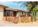 Close up of house entrance featuring desert landscaping, a gate and mature tree at 14418 N San Carlos Dr, Fountain Hills, AZ 85268