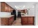 Modern kitchen with wood cabinets, black appliances, and skylights, seamlessly connected to other rooms at 14418 N San Carlos Dr, Fountain Hills, AZ 85268