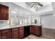 Bright kitchen with wood cabinets, offering a view to an outdoor patio through the clear glass windows at 14418 N San Carlos Dr, Fountain Hills, AZ 85268