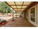 A covered patio features stone flooring, a backyard outdoor kitchen and landscaped yard at 14418 N San Carlos Dr, Fountain Hills, AZ 85268