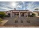Rear view of a well-kept home, featuring a covered patio and low-maintenance landscaping at 15864 W Clearwater Way, Surprise, AZ 85374