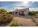 View of the back of the house and gravel-filled backyard, showcasing desert landscaping at 15864 W Clearwater Way, Surprise, AZ 85374