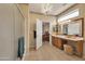 Charming bathroom has tile flooring, a vanity with makeup lighting, and an adjacent shower area at 15864 W Clearwater Way, Surprise, AZ 85374